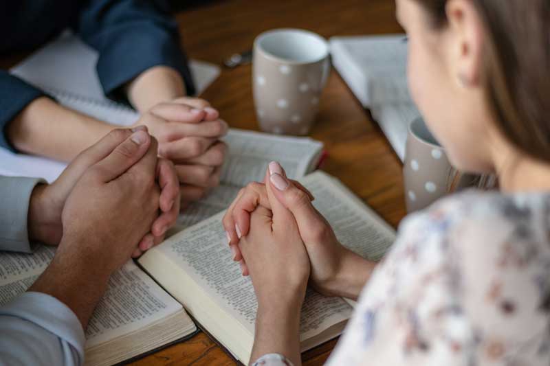 Bible study group praying