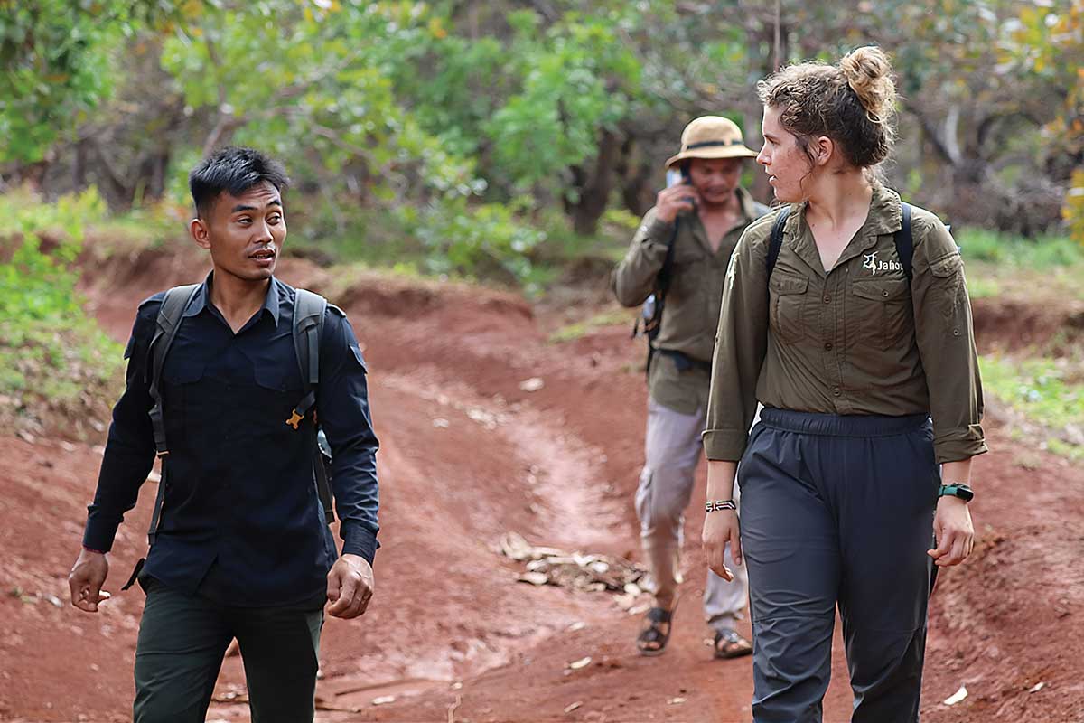 Recent alumna Kelly Mohnkern walking with guides in Cambodia.