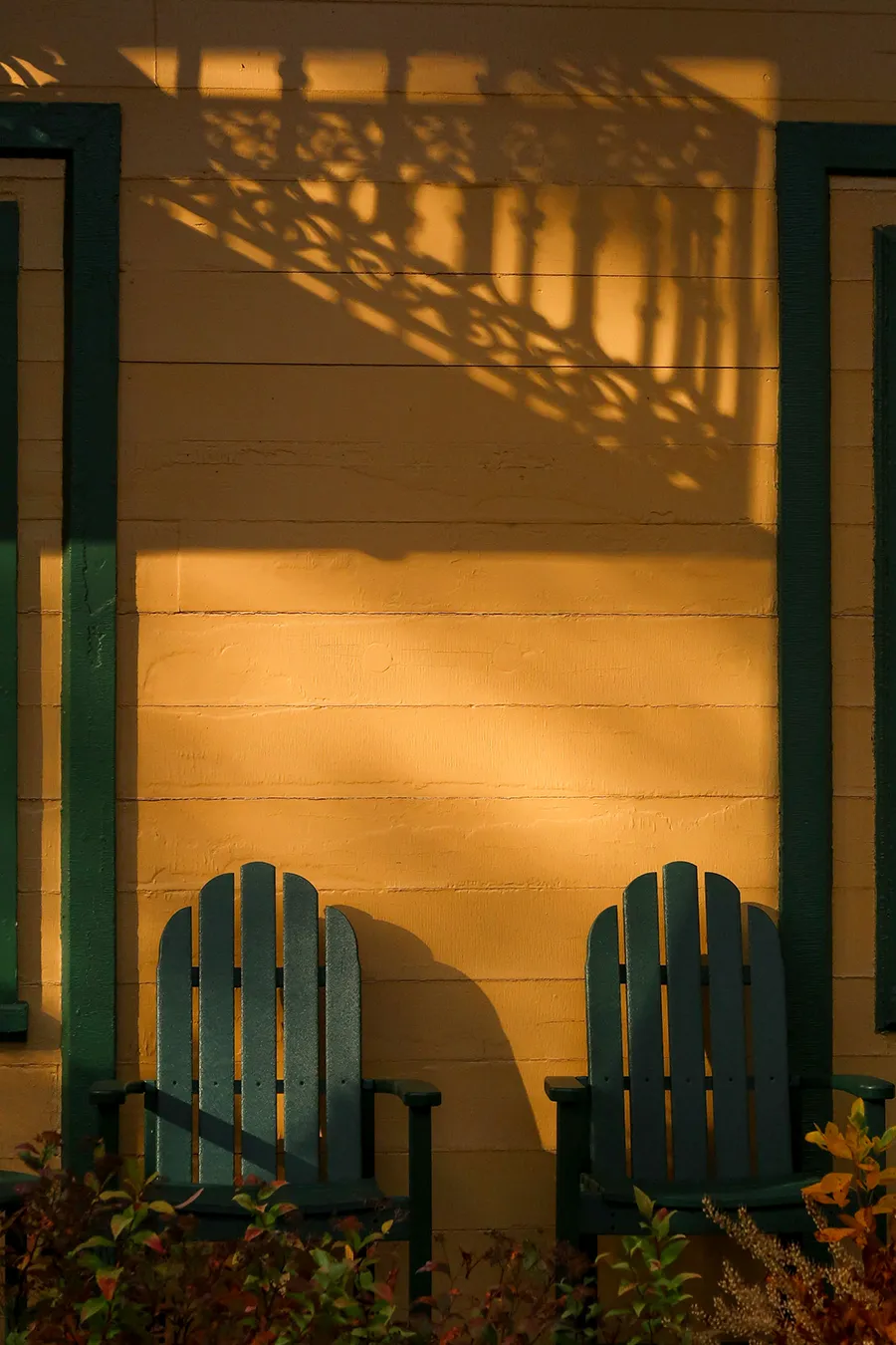 Houghton University Student photography illustration by Kaitlyn Avery for Senior Exhibition. Two green chairs by a yellow wall.