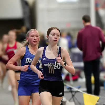 Student running indoor track